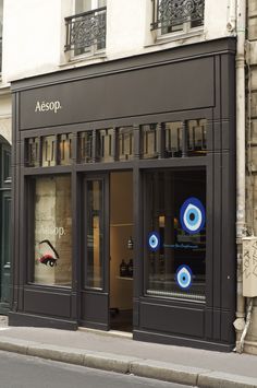 a store front with blue eyeballs in the window