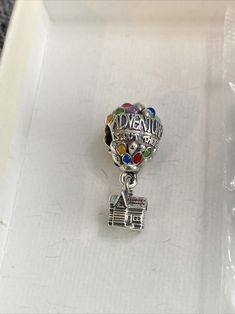 Add a touch of whimsy to your PANDORA bracelet with this authentic Disney PIXAR UP House & Balloons Charm Pendant. This charming piece features a colorful design that captures the essence of the beloved movie. The dangle charm style adds a playful touch to your jewelry collection, making it perfect for any occasion. Whether you're a fan of the movie or simply looking for a unique addition to your PANDORA bracelet, this charm is sure to delight. Pandora Movie, Beloved Movie, Pandora Disney, Disney Pixar Up, Up House, Dangle Charms, Pandora Bracelet, Bracelets And Charms, Pandora Charms