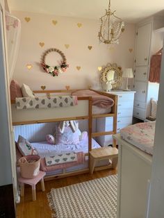 a bedroom with two bunk beds and a chandelier hanging from the ceiling above it