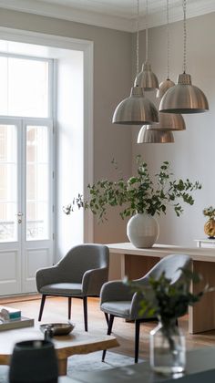 a living room filled with furniture and lots of lights hanging from it's ceiling