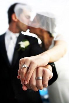 the bride and groom are holding hands with each other