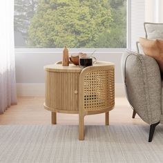 a living room with a couch, chair and table in front of a large window