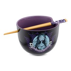 a purple bowl with two chopsticks in it and a drawing on the side