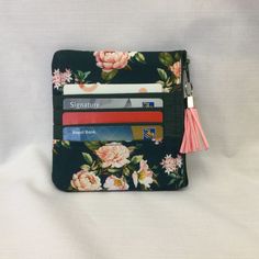 "This small lightweight pouch will easily accommodate your cash, credit cards and loose coins and will fit nicely into a back pocket or handbag. The fabric is cotton print with delicate pink roses on a dark green background. Fabric on credit card slots is matching dark green cotton. Wallet is lined with solid dark green cotton fabric and is interfaced with lightweight batting to give it a soft and puffy finish. A dark green zipper and a pink tassel pull complete this item. This mini purse featur Green Coin Purse Pouch With Card Slots, Pink Coin Purse With Card Slots For Personal Use, Pink Pouch Coin Purse With Card Slots, Compact Pink Coin Purse With Removable Pouch, Cotton Wallet, Pink Rfid-blocking Rectangular Coin Purse, Fabric Wallet, Dark Green Background, Pink Tassel