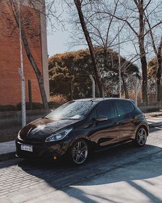 a small black car parked on the street