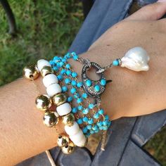 This feminine and elegant bracelet is a composition of turquoise chain, diamond and turquoise clasp and big white pearl and diamonds charm. You can wrap this bracelet around your wrist 3 times or even wear it as a necklace. Wear this bracelet by itself or layer with: https://www.etsy.com/listing/825660072/glass-bead-tie-bracelet-pony-bead?ref=shop_home_active_9&frs=1 You might also like: https://www.etsy.com/listing/513908525/turquoise-and-pave-diamonds-bracelet?ref=shop_home_active_6&fr Turquoise Single Strand Bracelet As Gift, Turquoise Single Strand Bracelet Gift, Turquoise Single Strand Bracelet For Gift, Elegant Turquoise Bracelet Jewelry, Elegant Turquoise Bracelet, Elegant Single Strand Turquoise Bracelet, Elegant Turquoise Bracelets With Natural Stones, Elegant Turquoise Beaded Bracelets, Elegant Turquoise Pearl Bracelet For Gift