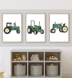 three green tractors are hanging on the wall next to bookshelves in a child's room