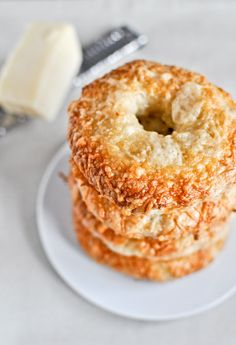 three fried donuts on a plate with butter