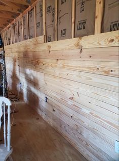 a room that has some wooden walls and chairs in it with boxes on the wall