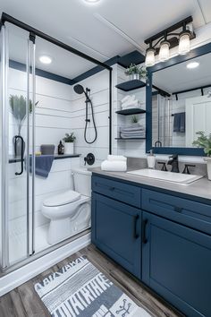 a bathroom with blue cabinets and white walls