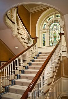 a staircase with stained glass windows and white railings