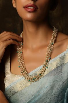 This necklace has turquoise stones scattered amidst a sea of shell pearls, lending its whimsical charm. The necklace is at once opulent and nostalgic making it a great pair for all traditional affairs. Closure - Lobster Style Tip -This tasteful design with oodles of luxurious details will keep you hooked every time you look at them. The mesmerizing play of light and textures is something to behold and own. Reflecting on the traditional richness we create designs that are an amalgam of traditiona Turquoise Pearl Jewelry With Pearl Charm, Elegant Turquoise Pearl Jewelry With Pearl Charm, Handmade Turquoise Pearl Necklace, Turquoise Pearl Necklace With Pearl Charm As Gift, Turquoise Pearl Jewelry With Round Beads, Turquoise Pearl Necklace Gift, Turquoise Pearl Drop Jewelry, Turquoise Pearl Beaded Necklace For Gift, Turquoise Pearl Necklace With Round Beads