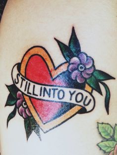 a tattoo that says still into you on it