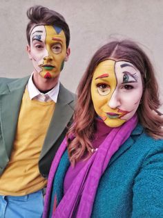 two people with painted faces standing next to each other