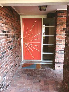 a red door is open on a brick building