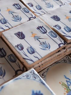 several blue and white plates stacked on top of each other with flowers painted on them