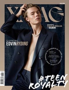 a young man in a suit on the cover of a magazine, with his shirt pulled back