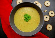 a bowl of soup with crackers on the side