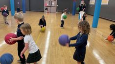 children playing with balls in an indoor gym