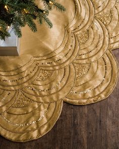 gold placemats with christmas tree in the background