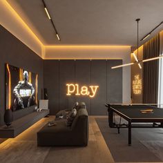 a game room with ping pong tables and neon signs on the wall above it