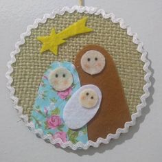 a christmas ornament with two baby bears and a star on it's side