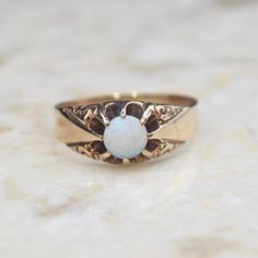 Antique Victorian 14k gold ring with a round opal cabochon set in a belcher claw setting. The top corners of the band are decorated with a scrolling design. The inside of the band is inscribed W.C.A. Era: Victorian c.1880s Markings: None Materials: 14k gold, opal Ring Size: 9.5 (comes with one free resizing by our jeweler) Weight: 3.4 grams Condition: Excellent antique condition with minor surface wear from age  Shipping is free in the United States Follow us on Instagram @LUXXORVintage Victorian Luxury Gold Opal Ring, Luxury Victorian Opal Ring, Victorian 14k Gold Cabochon Opal Ring, Victorian Style Gold Opal Ring With Multi-stone, 14k Gold Opal Ring, Antique 14k Gold Opal Ring, Oval Cabochon, Gold Opal Ring, Hudson Ny, Opal Ring Gold