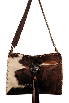 Natural tri-color hair on cow front with brown leather front, sides and back. Brass D-Rings attach to a removable leather handle with metal accents. Hand laced with saddle tan deer lace and tassel and metal concho accent. This bag is fabric lined and has interior pockets. A classic western handbag to compliment your collection!Handmade in the USA.Custom made to order. Sorry, no returns.Please allow 2-3 weeks for shipping.Dimensions: 13 x 11 Brown Calf Hair Shoulder Bag With Leather Handles, Brown Calf Hair Satchel Shoulder Bag, Brown Calf Hair Tote Shoulder Bag, Western Handbags, Western Leather, D Rings, Metal Accents, Metallic Accents, Tri Color