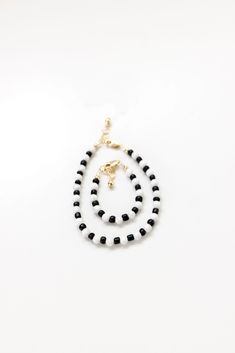 Karisma, from the beautiful aspen- marble bead to the matte finished black bead. You can't go wrong with this classic black and white design. The perfect accessory for every mom + her mini! Made with the highest quality materials, this bracelet will look beautiful for years to come. Durable enough for play, precious enough to keep forever. Materials: 14k gold filled or sterling silver components. Nickel free. To learn more about our materials and what makes gold filled unique read here. Features Adjustable Black And White Beaded Jewelry, White Bracelets With Round Black Beads, White Bracelets With Black Beads, Elegant White Bracelets With Black Beads, Elegant White Bracelet With Black Beads, Black And White Round Bead Jewelry, Teething Babies, Mini Bracelet, Diy Gift Card