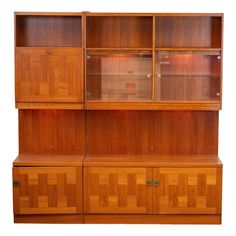 a wooden bookcase with glass doors and drawers