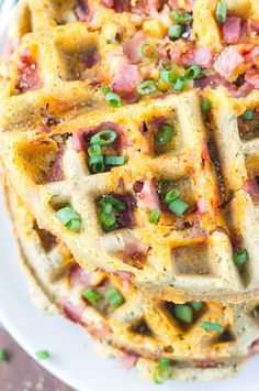 a waffle topped with bacon and green onions