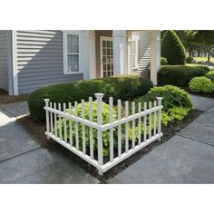 a white picket fence in front of a house