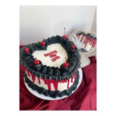 a heart shaped cake with the word i love you written on it and cherries