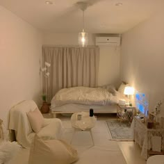 a living room filled with furniture next to a white couch and table in front of a window