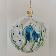 a glass ornament shaped like a blue fish