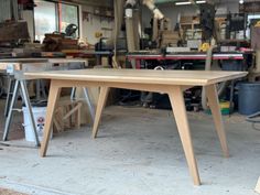 a wooden table sitting inside of a garage