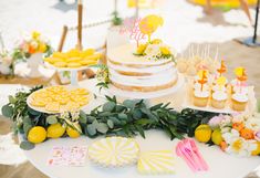 a table topped with lots of cakes and desserts