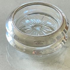 an empty glass bowl on top of a table