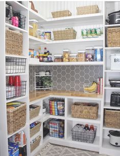 an organized pantry with white shelves and baskets