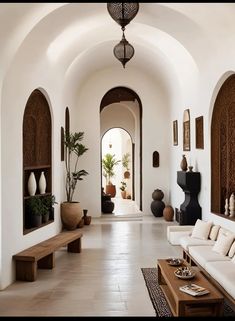 a living room filled with lots of white furniture