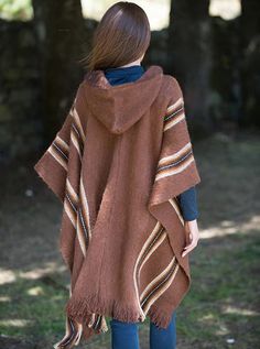 Hooded rustic poncho with brown and white stripes. Handmade in alpaca and lamb wool, this poncho will keep you warm in cold winter days.Overview: Material: Wool Blend. Color: Brown. Crewneck Hooded Size:Length: 90 cm (35.43")Width: 110 cm (43.30")It refers to the total measurements of the poncho when it is fully open (like a blanket)Note: Since this garment is hand-crafted, there might be some variations in color and details of descriptions. Winter Poncho, Brown Crewneck, Color Cafe, Cold Winter, Ponchos, Fedora, Alpaca, White Stripe, Wool Blend