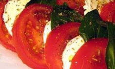 sliced tomatoes and spinach on a cutting board