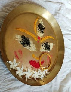 a gold plate with flowers and scissors on it