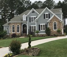 a gray house with white trim and black shutters