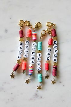 two key chains with words on them and stars hanging from the end of each one