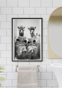 two llamas reading books while sitting on a toilet in a bathroom with white tiled walls