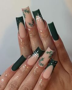 This intricate design showcases long, square nails with a nude base and frosty green tips. Delicate holly leaves and snowflakes are carefully painted on each nail, creating a festive and detailed holiday scene. The matte finish adds a touch of elegance to this playful and festive design. Winter Nails Acrylic Dark Green, Christmas Nails Coffin Shape Green, Long Nails For Christmas, Winter Nails Dark Colors, Hunter Green And White Nails, Shiny Emerald Green Nails, Grungy Christmas Nails, Green Nails With Snowflake Design, Xmas Inspired Nails