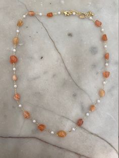 Gold-plated orange agate and pearl beaded necklace. The necklace measures 16 inches with a 2 inch extender. Orange Pearl Necklace, Fall Necklaces, Orange Beaded Necklace, Fall Necklace, Dainty Jewellery, Pearl Beaded Necklace, Autumn Necklace, Orange Necklace, Orange Agate