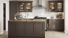 a kitchen with wooden floors and gray cabinets