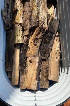 a pile of wood sitting inside of a container